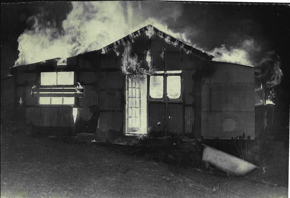 A vacant house in Austinmer burns during the October 1968 bushfires. It would be one of the more than 30 homes lost.