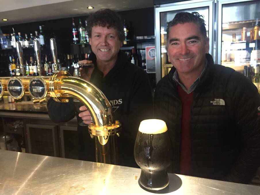 Cheers: Brewer Cameron James and owner Ben Twomey from Southern Highlands Brewing with their gold-medal winning porter, the Goodfather. Picture: Michelle Thomas