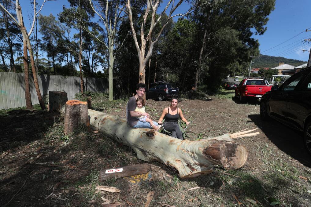 Ben and Michaela Hewitt with daughter Eulalia at the patch of cleared land along Dumfries Avenue at Mt Ousley, which they say was done without consultation. Picture by Robert Peet