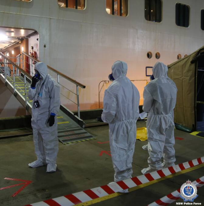 Search: Police detectives donned protective clothing before boarding the Ruby Princess as part of an investigation into passengers disembarking in Sydney last month. Picture: NSW Police