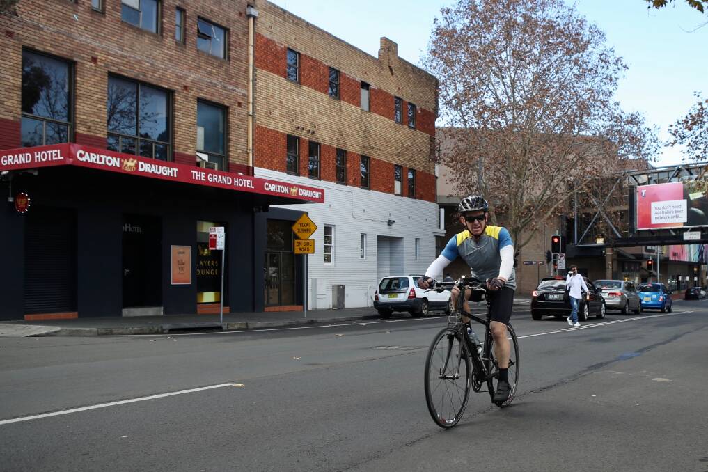 Traffic: A cyclist riding down Burelli Street ... a cycling group has suggested making the street one-way to open up more space for riders to use it safely. Picture: Adam McLean