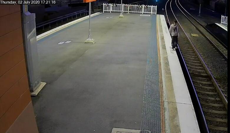 Look out: A man, apparently drunk, just before he walks straight off the edge of the train platform in a still from a video released on Monday. Picture: Transport for NSW