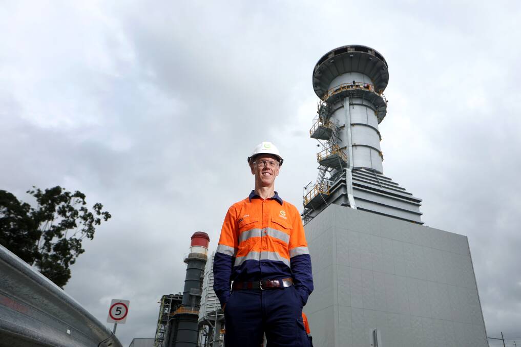 EnergyAustralia's managing director Mark Collette with the new Tallawarra B power station with the unique disc-shaped plume dispersion device at the top of the tower. It is designed to limit any effects on aircraft from the nearby Shelllharbour Airport. Picture by Sylvia Liber 