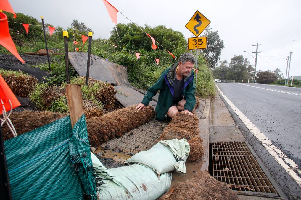 Wombarra resident Brian Murphy inspects efforts to reduce run-off from a construction site in his suburb earlier this month. Wollongong City Council is taking measures to remind companies of their responsibilities. Picture: Anna Warr