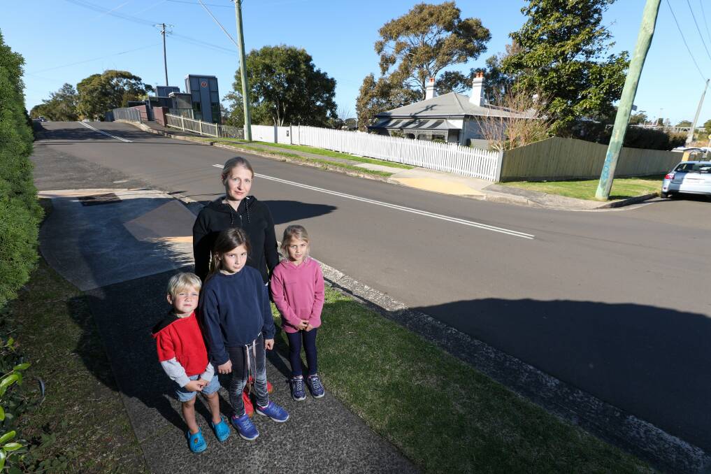 Cross: Safe Streets for Schools member Lena Huda with her children Alex, Jojo and Hanna, at Park Road, Bulli, where her group would like to see a pedestrian crossing. Picture: Adam McLean