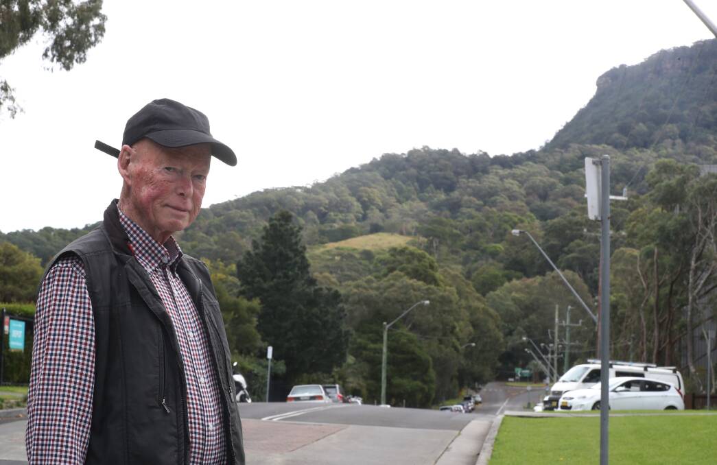 Keiraville Residents Action Group member Geoff Kelly with the area of the escarpment in the background that had been proposed for development. Picture by Robert Peet
