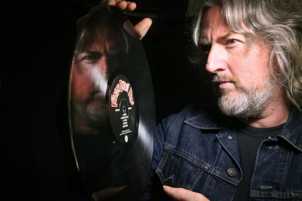 History: Proton Energy Pills guitarist Stewart Cunningham with the new vinyl release of the band's back catalogue. Picture: Sylvia Liber