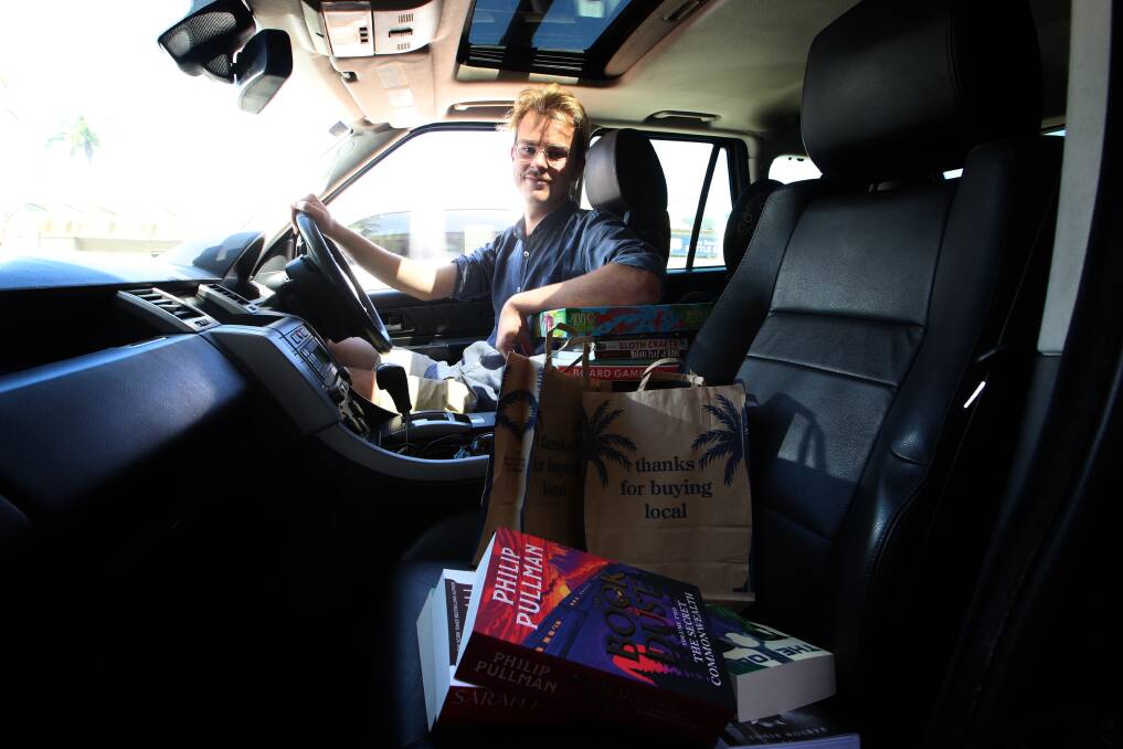 Rolling: Drive Angus Woodiwiss with another batch of local deliveries from Collins Booksellers in Thirroul. Picture: Sylvia Liber
