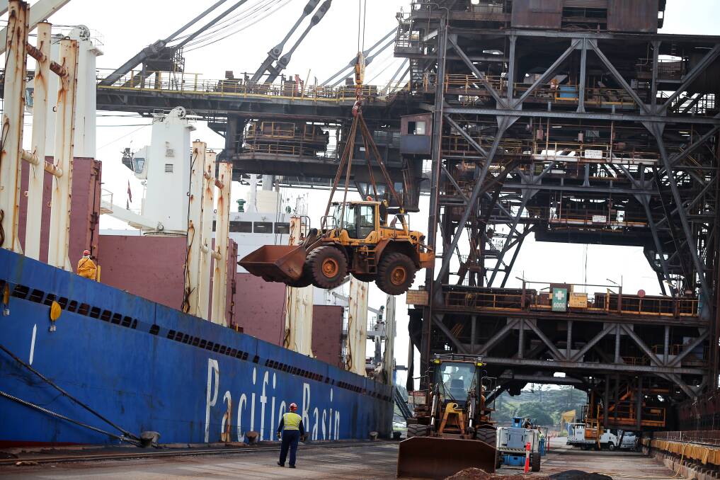 A front-end loader being lifted into a ship's hold by crane on the BlueScope berths at Port Kembla ...an accident on Monday saw a loader fall from the crane and damage a ship. Picture: Sylvia Liber
