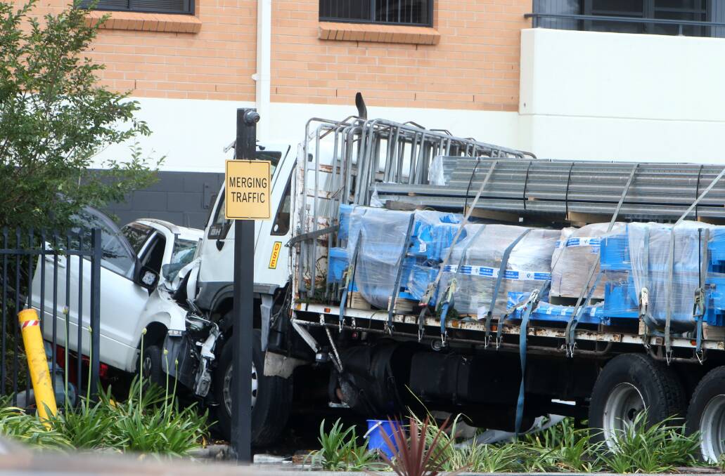 A runaway truck ploughed through the car park of the McDonald's at Fairy Meadow, wedging an SUV up against an apartment block. Picture: Sylvia Liber