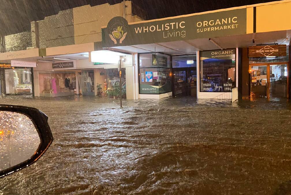The main street of the Woonona CBD under water in the early hours of Saturday morning. Picture by Mark Hall