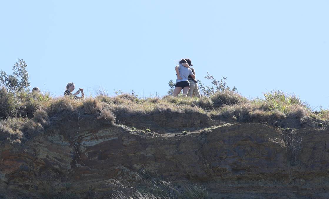 Foolish: Just a day after a man fell to his death above Sea Cliff Bridge, more people are seen taking selfies at the same spot. Picture: Adam McLean