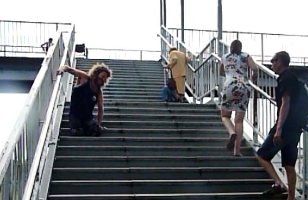 Toby Lyndon pulls himself up the Unanderra station stairs in the 2015 video that went viral.