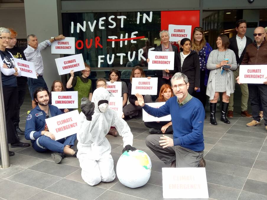 Time's up: UOW lecturer Keith Horton (right) with arts student Toby Thompson and other protesters calling for a climate emergency declaration. 