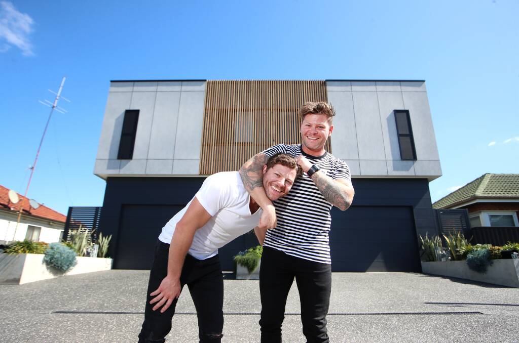 Twins Josh and Rhys Cochrane outside their identical homes in Wollongong. Picture by Sylvia Liber