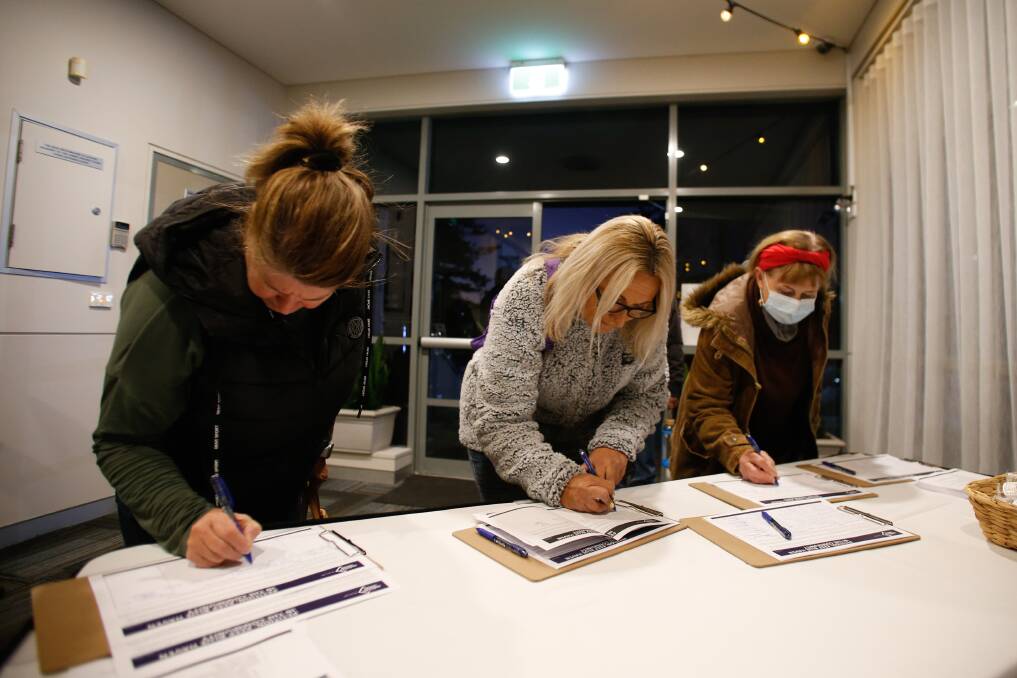 Kiama residents signing a petition calling on state and federal governments to intervene to help save the Blue Haven aged care facility. Picture: Anna Warr