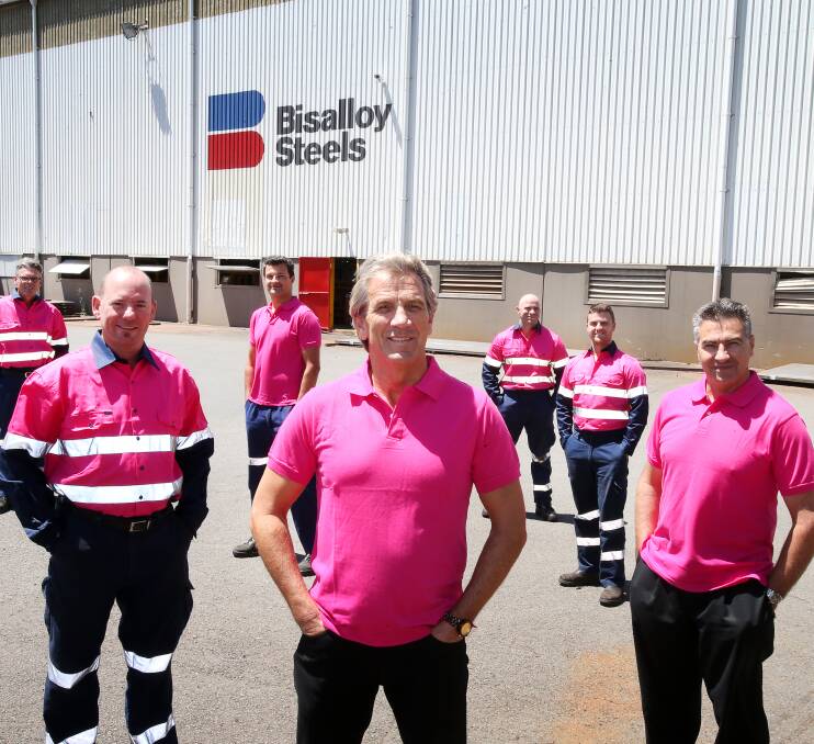 think pink: Bisalloy Steels Operations Manager Michael Bradmore and employees sporting the pink shirts and hi-vis wear. Picture: Sylvia Liber