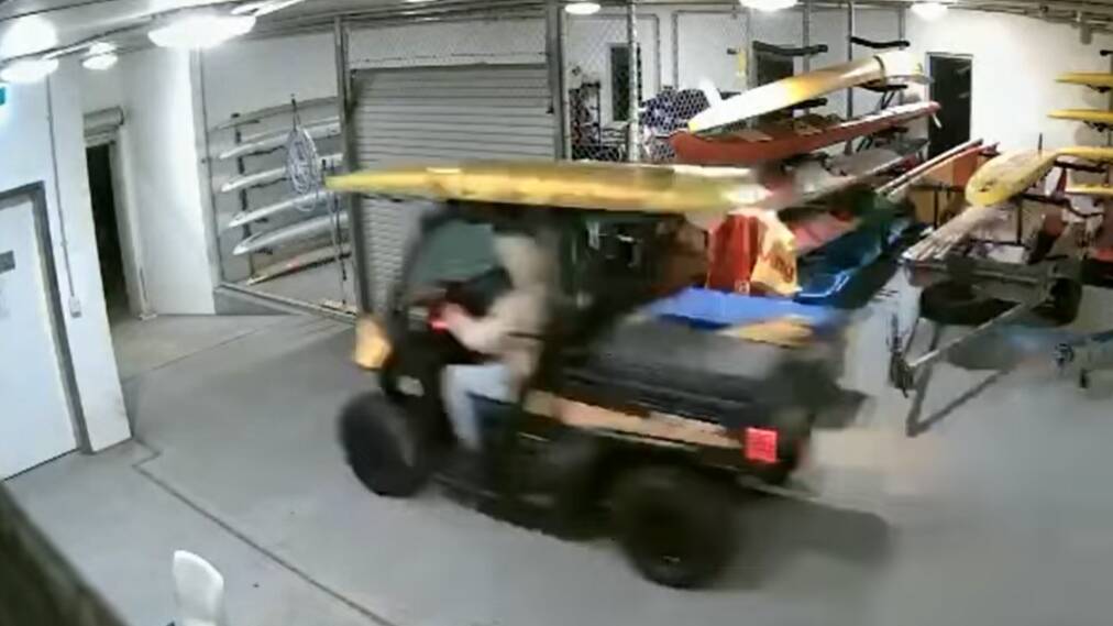A CCTV still showing one of the thieves driving away with the buggy from Bulli Surf Club. Picture: supplied