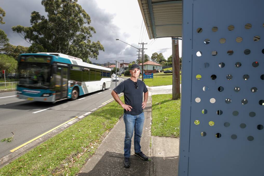 Anthony Horneman at a Bulli bus stop where the timetable says the Premier No2 bus is supposed to stop - but it doesn't. Picture: Adam McLean