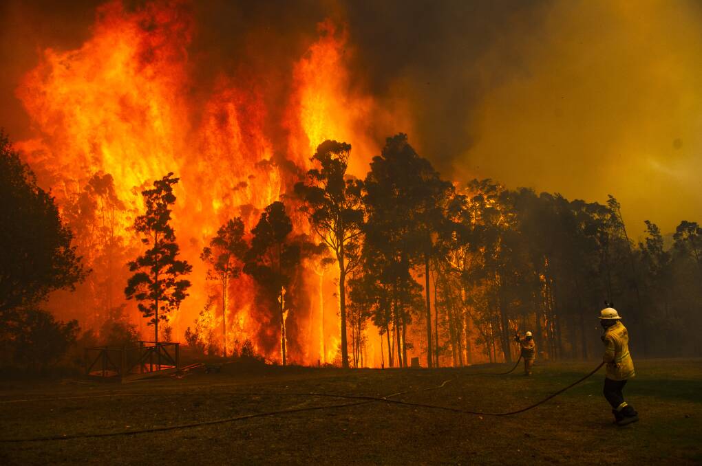RFS crews battling the Currowan fire west of Ulladulla on December 21. Picture: Dion Georgopoulos