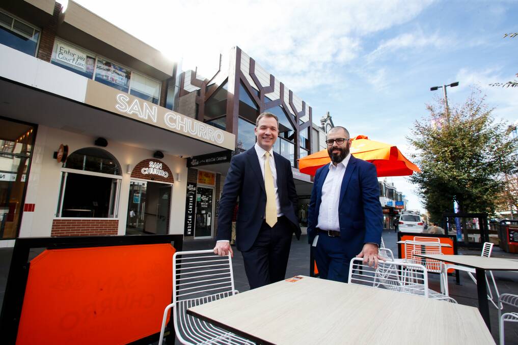Fresh air: Adam Zarth and Tim Fares from Business Illawarra at the outdoor dining at the new San Churro restaurant in the mall - they would like to see more venues offer the same experience. Picture: Anna Warr