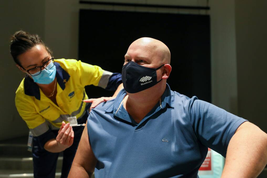 Jab: BlueScope's Michael Reay gets his COVID vaccination at the steelworks from company nurse Stephanie Bruseker. The steelmaker has launched in in-house vaccination program. Picture: Adam McLean