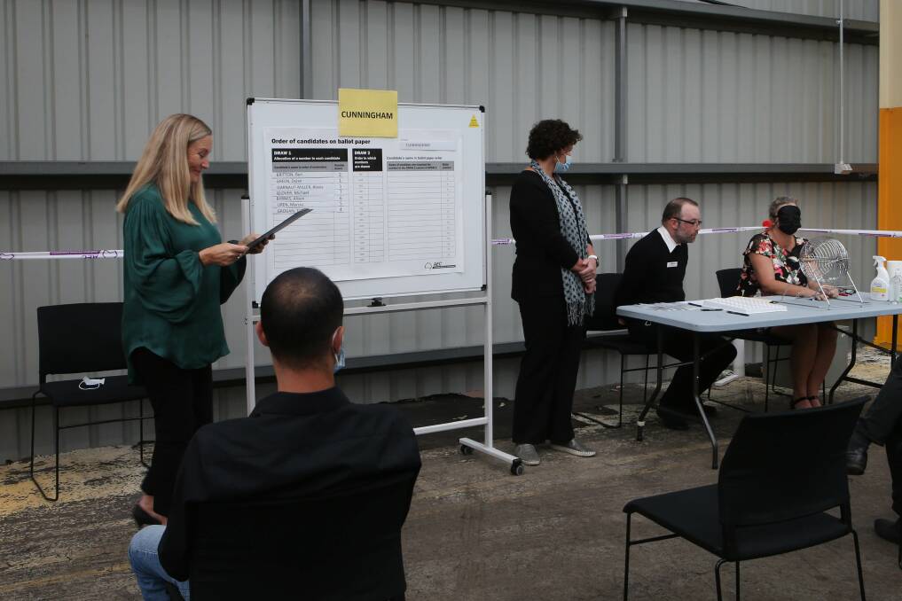 Draw: Australian Electoral Commission officials carry out the draw for ballot order in the seat of Cunningham on Friday, where Liberal candidate Marcus Uren grabbed the top spot. Picture: Sylvia Liber