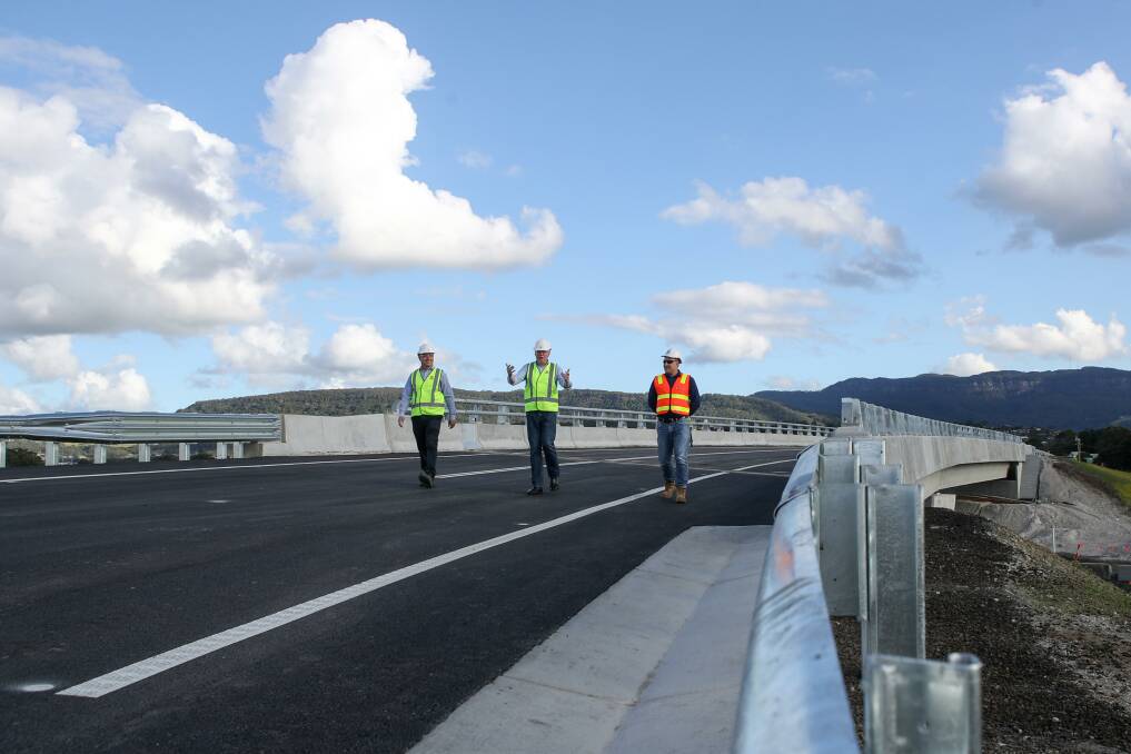 Warren Blacka from Transport for NSW, Kiama MP Gareth Ward and Fulton Hogan project director Matthew Saviana walk across the first of the 13 Albion Park Rail bypass bridges to open to traffic. Picture: Adam McLean