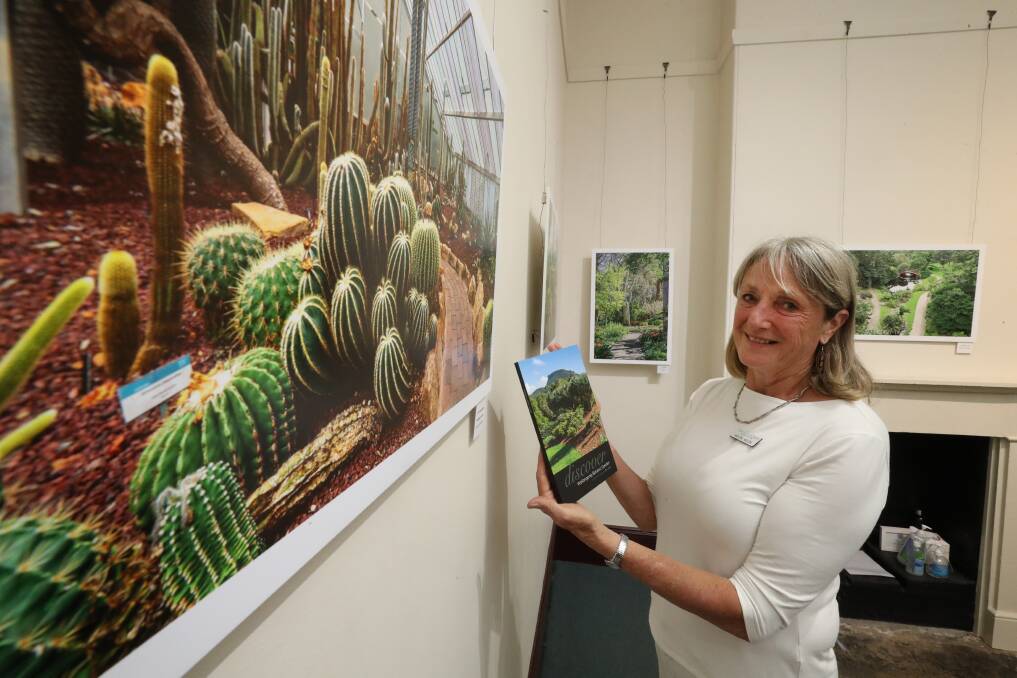 History: Friends of the Botanic Garden vice-president Helen Moon with a new book that marks the 50th anniversary of the garden. Picture: Robert Peet