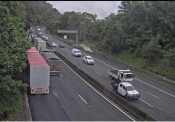 Trucks parked in the northbound lanes of the M1 Princes Motorway waiting for a fallen tree to be removed.