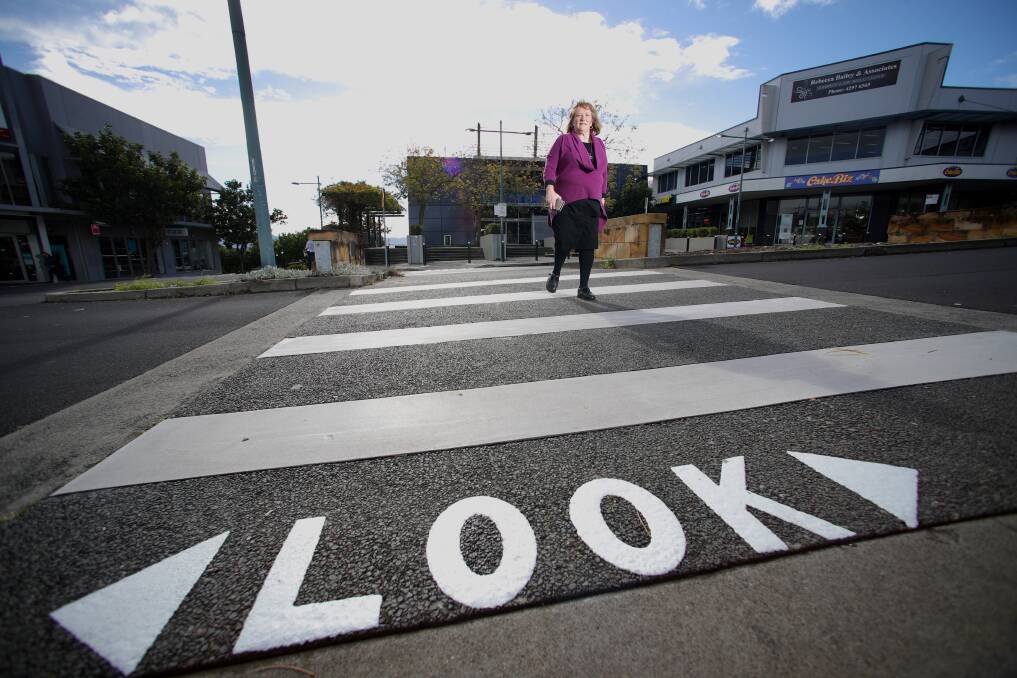 Heads up: Shellharbour Mayor Marianne Saliba at a crossing with the new warnings to try and get mobile phone users to look up before they cross. Picture: Adam McLean