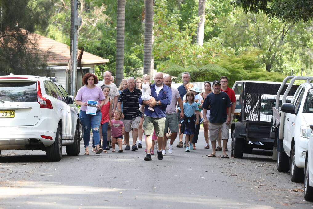 Trucks: Alastair McGill with his daughter Luna and other residents of Wilsons Creek Road at Helensburgh, who are concerned about the prospect of heavy vehicles in their street. Picture: Robert Peet