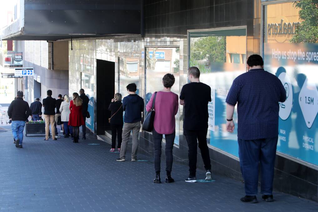 People lining up for their shot at the Wollongong vaccination hub - Wollongong MP Paul Scully wants to see more doses delivered to the clinic. Picture: Sylvia Liber
