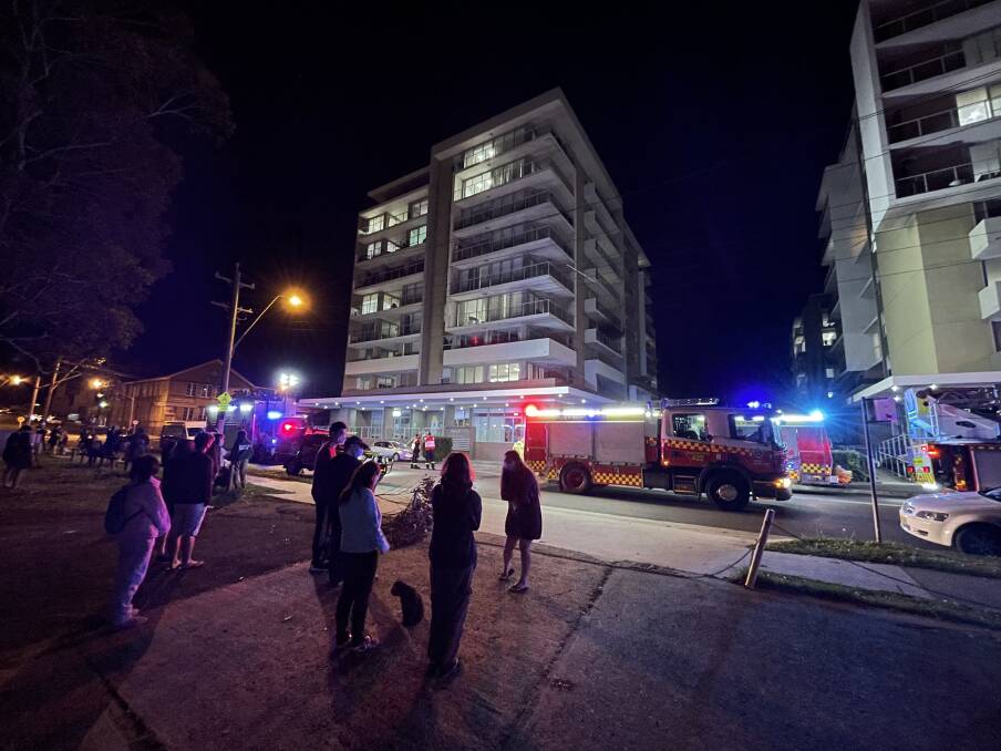 Residents of a Gladstone Avenue apartment complex outside after a fire on Monday night. There are concerns that may be when some residents were exposed to the COVID virus. Picture: Adam McLean