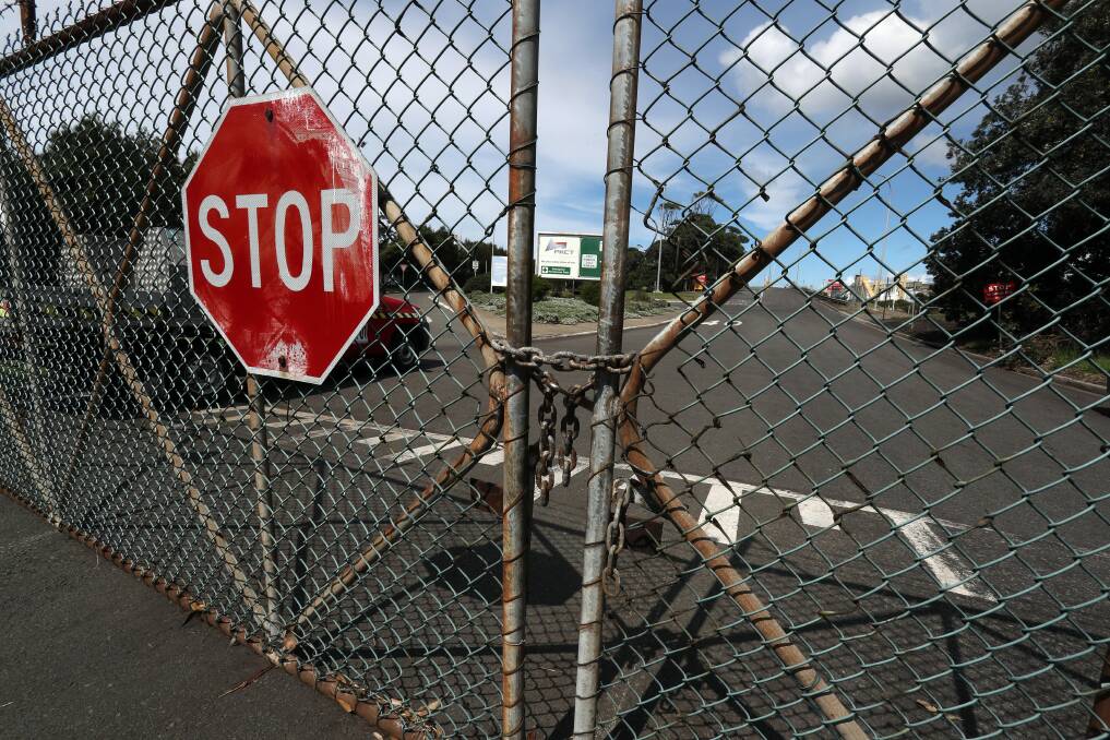 Questions: The locked gates at the Port Kembla Coal Terminal ... a union ban on trucks entering the site may not be legal. Picture: Robert Peet