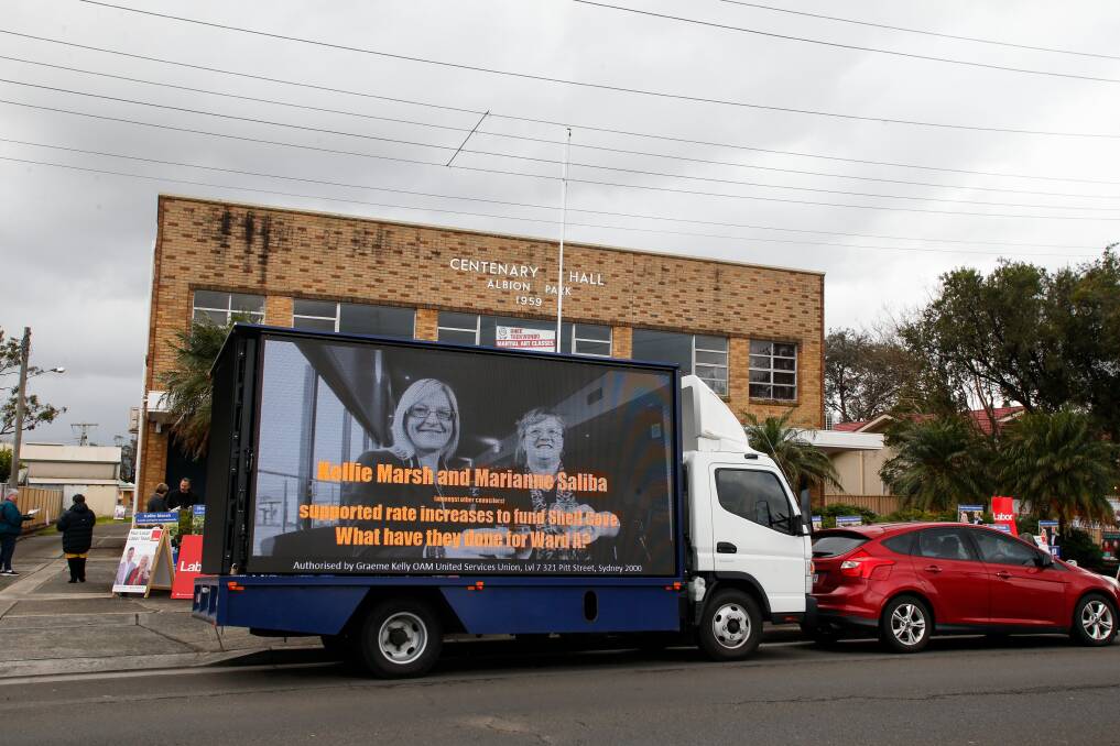Rough: A truck-mounted billboard outside the Shellharbour Ward A pre-poll booths, part of an election that has become ugly. Picture: Anna Warr
