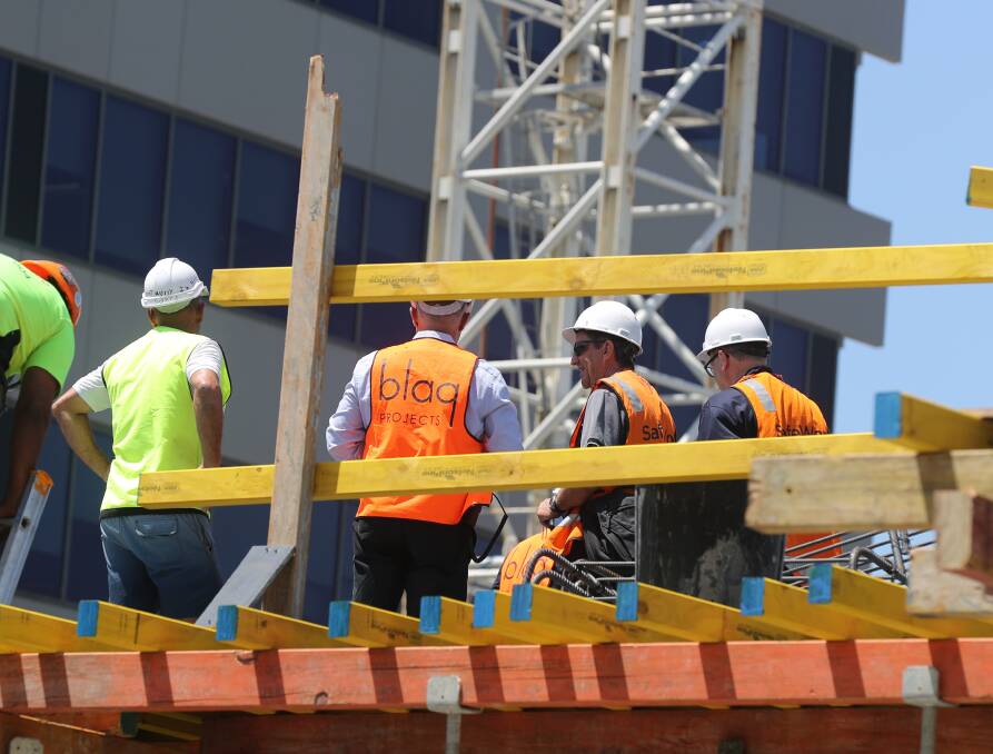 Inspection: Two SafeWork NSW inspectors (at right) on a Wollongong CBD building site on Tuesday at the start of a three-day blitz in the Illawarra. Picture: Robert Peet