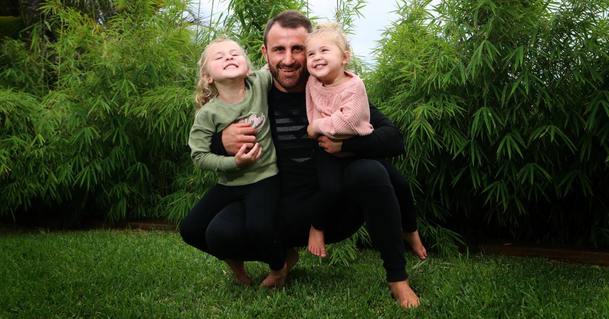 AT HOME: Alexander Volkanovski relaxes in Flinders with his daughters Airlie and Ariana. Picture: Sylvia Liber