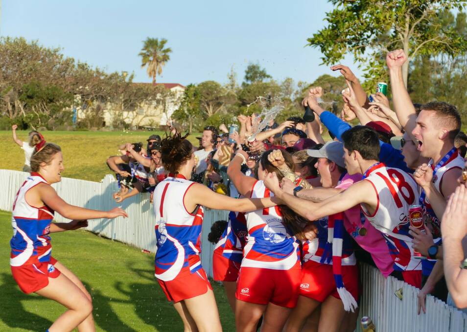 Bulldogs women's players and supporters embrace after Wollongong won the 2019 title. Picture: Dave Johnson/AFL South Coast