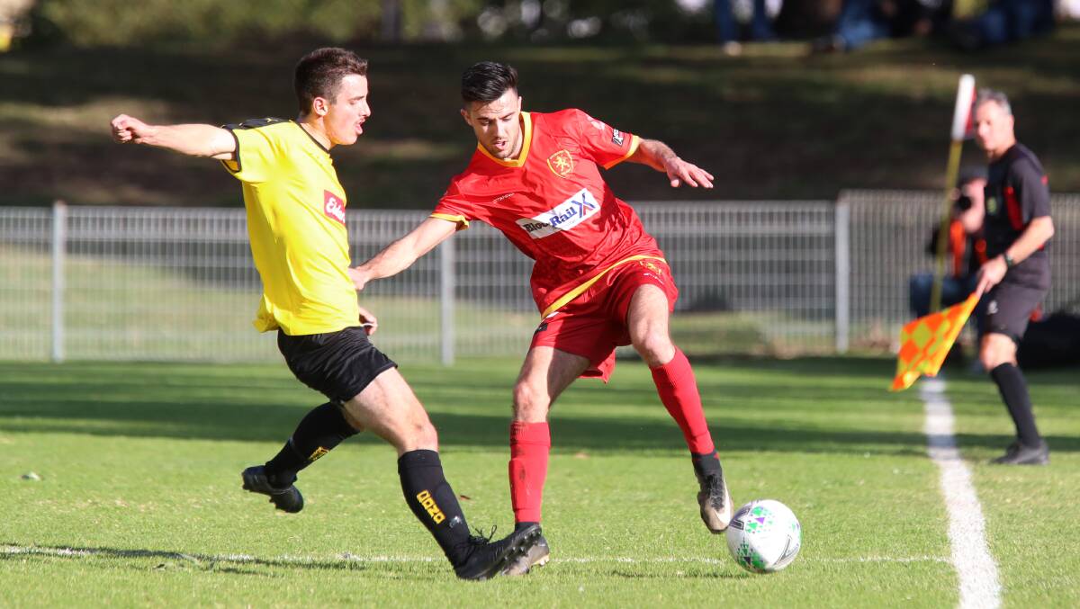 FOCUSED: Wollongong United's Andre Dias keeps the ball away from his Coniston opponent during last year's Frat Cup final. Picture: Sylvia Liber