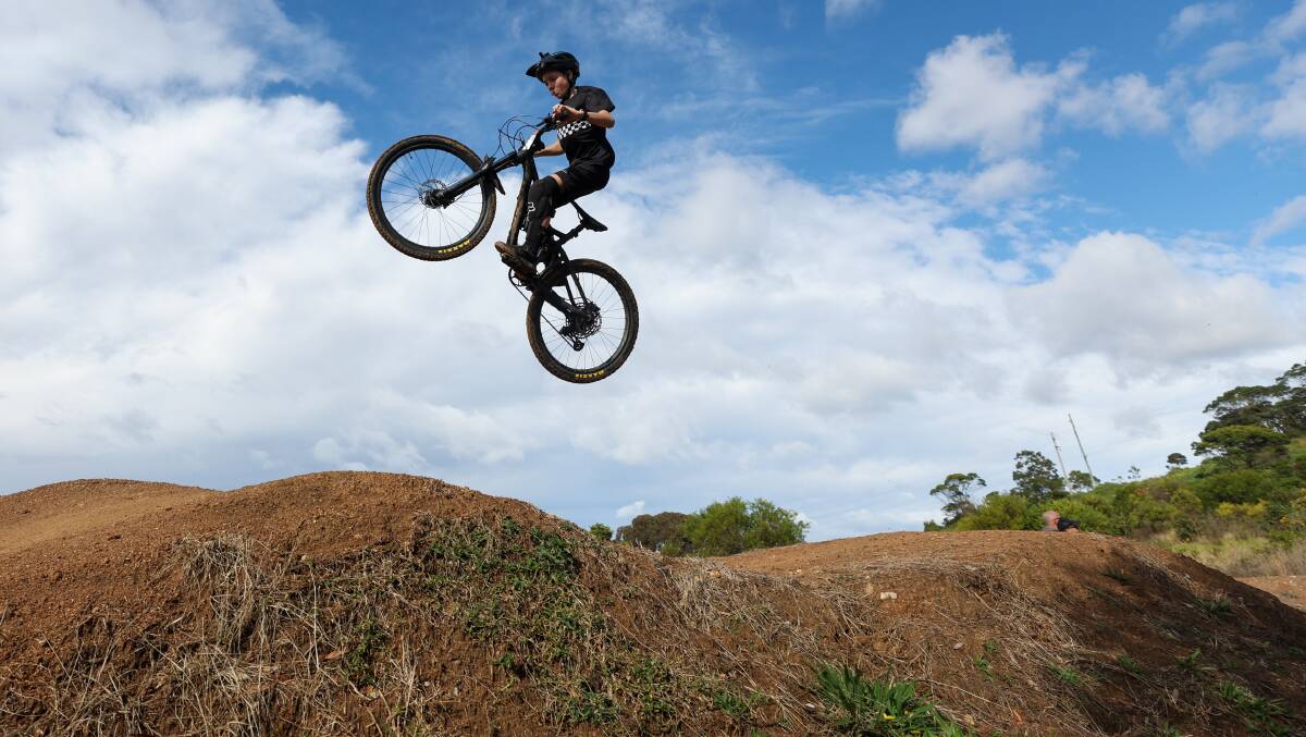 A student gets some impressive air time during the Illawarra MTB School Competition at Cringila MTB Park on Friday. Picture by Adam McLean