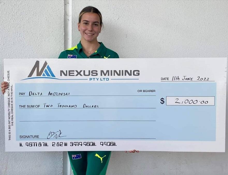 Delta Amidzovski with the presentation cheque from Nexus Mining. 