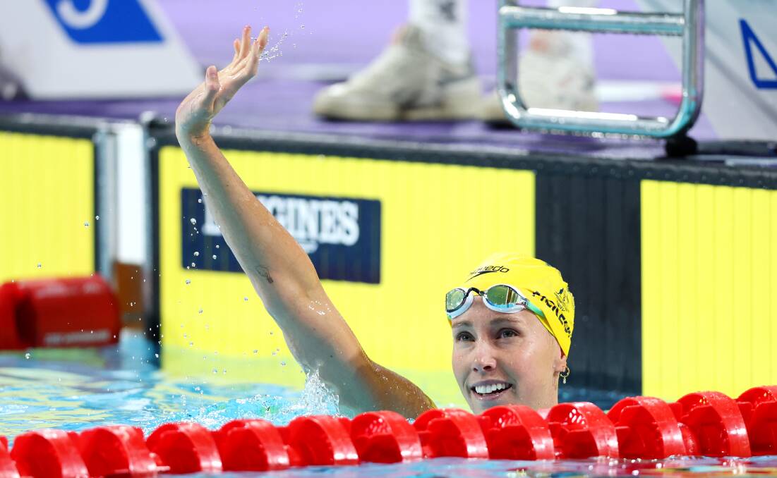 DELIGHT: Emma McKeon waves to the crowd after winning gold in the 50m women's butterfly final on Tuesday morning (AEDT). Picture: Brunskill/Getty Images