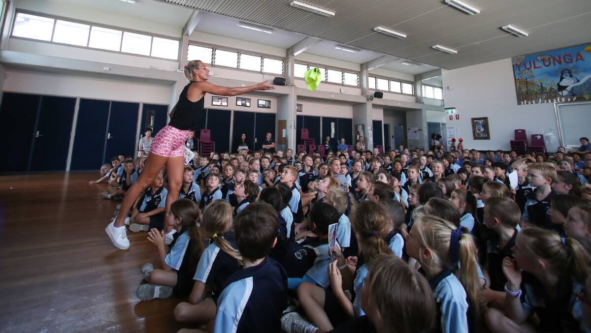 Courtney Hancock hands out a prize to St Joseph's Catholic Primary School students. Picture: Adam McLean