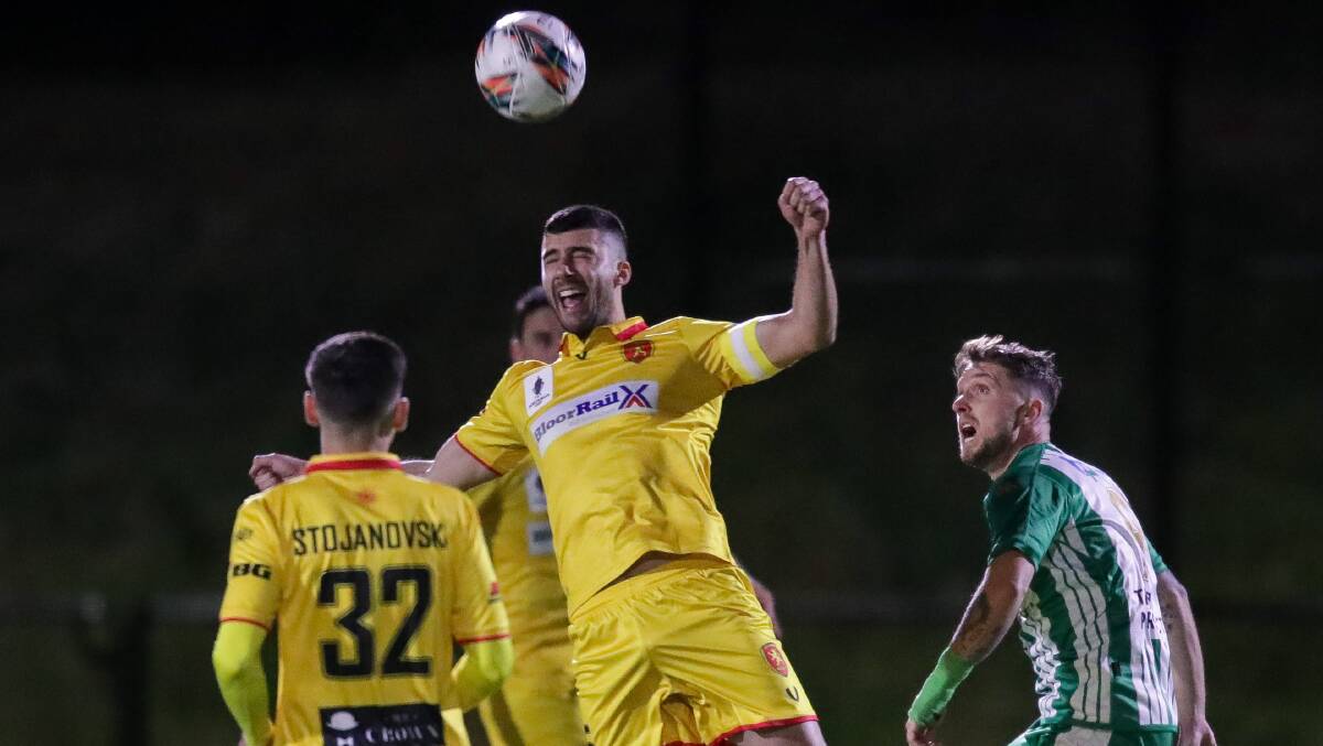 Danny Lazarevski jumps highest to head the ball during Wollongong United's Australia Cup national round of 32 fixture with Green Gully SC in 2022. Picture by Adam McLean