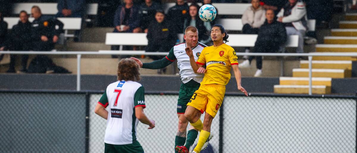 EYES ON THE PRIZE: United's Mitsuo Yamada (right) competes for possession with Bellambi's Brett Wilson on Sunday. Picture: Wesley Lonergan