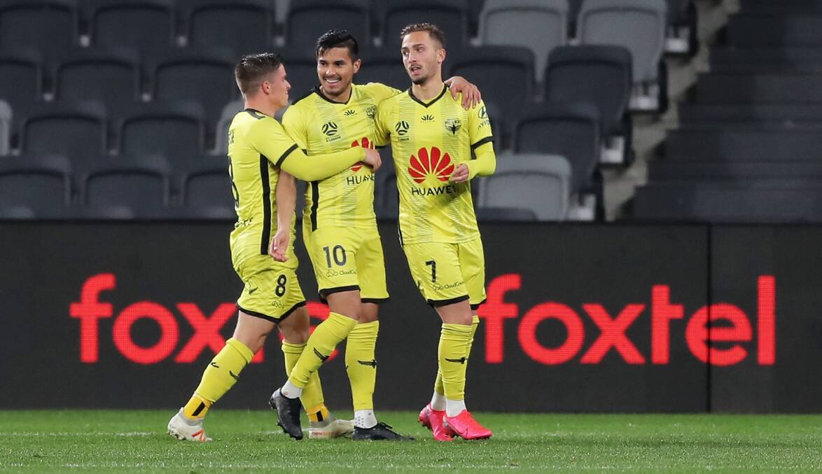HAPPY DAYS: Ulises Davila (centre) celebrates with his Phoenix teammates after scoring a goal against Perth Glory. Picture: Matt King/Getty Images