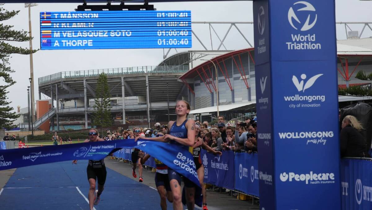 Sweden's Tilda Mansson crosses the line to win the elite women's race at Saturday's World Triathlon Cup in Wollongong. Picture by Sylvia Liber