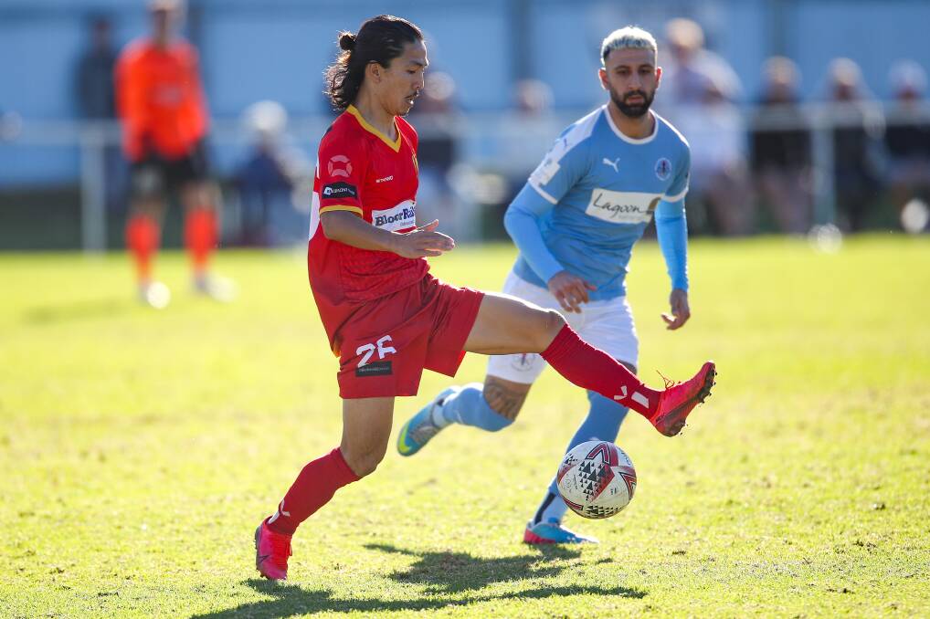 IN FOCUS: Wollongong United's Seiki Kawakami looks to pass the ball in front of Olympic opponent Van Elia. Picture: Adam McLean
