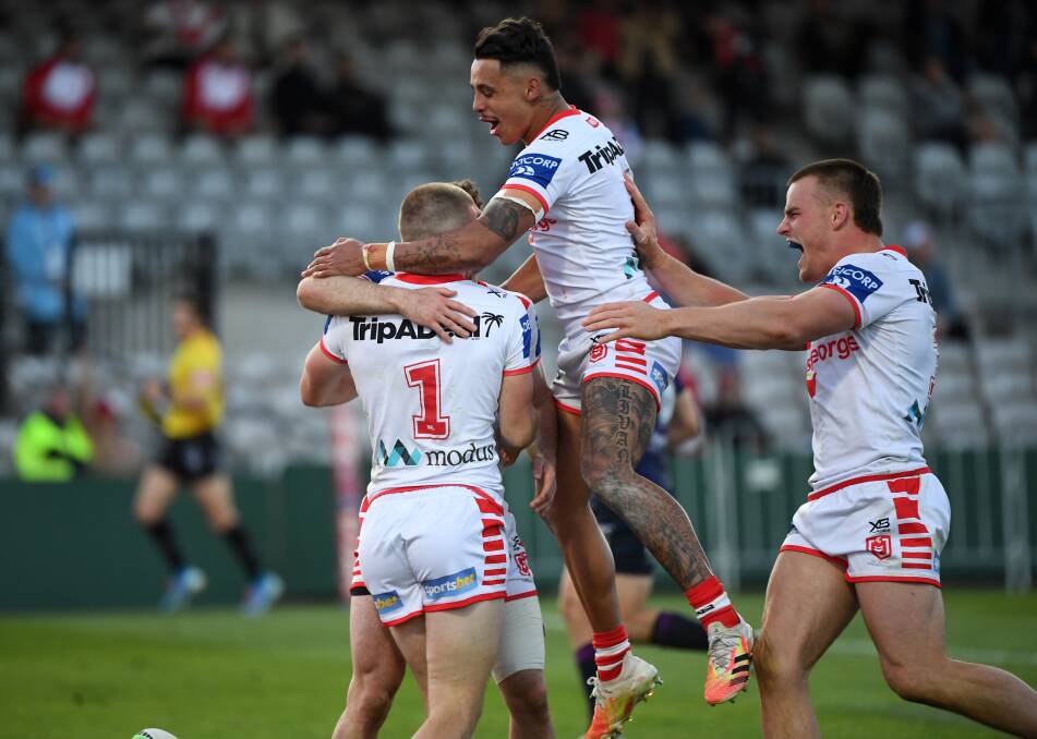 DELIGHT: Dragons players celebrate after fullback Matt Dufty dashes away to score his second try on Sunday against the Storm. Picture: Grant Trouville/NRL Imagery